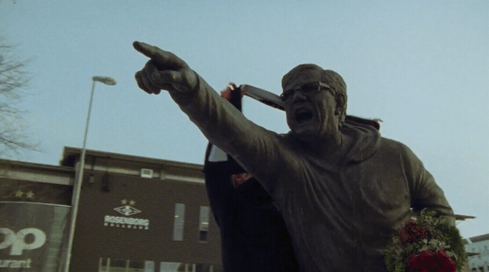 a statue of a man holding a baseball bat