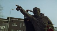 a statue of a man holding a baseball bat