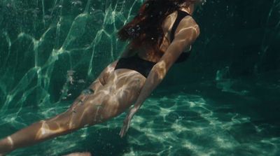 a woman in a black swimsuit in the water