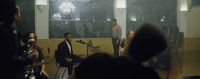 a group of people in a room with microphones