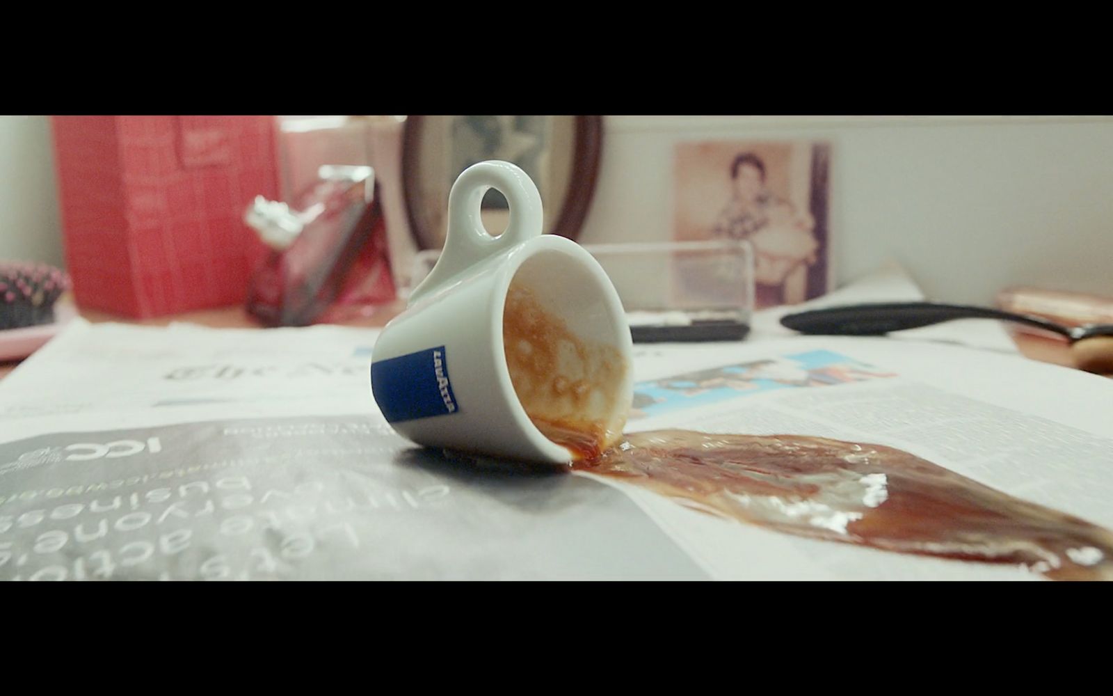 a cup of coffee spilled on top of a table