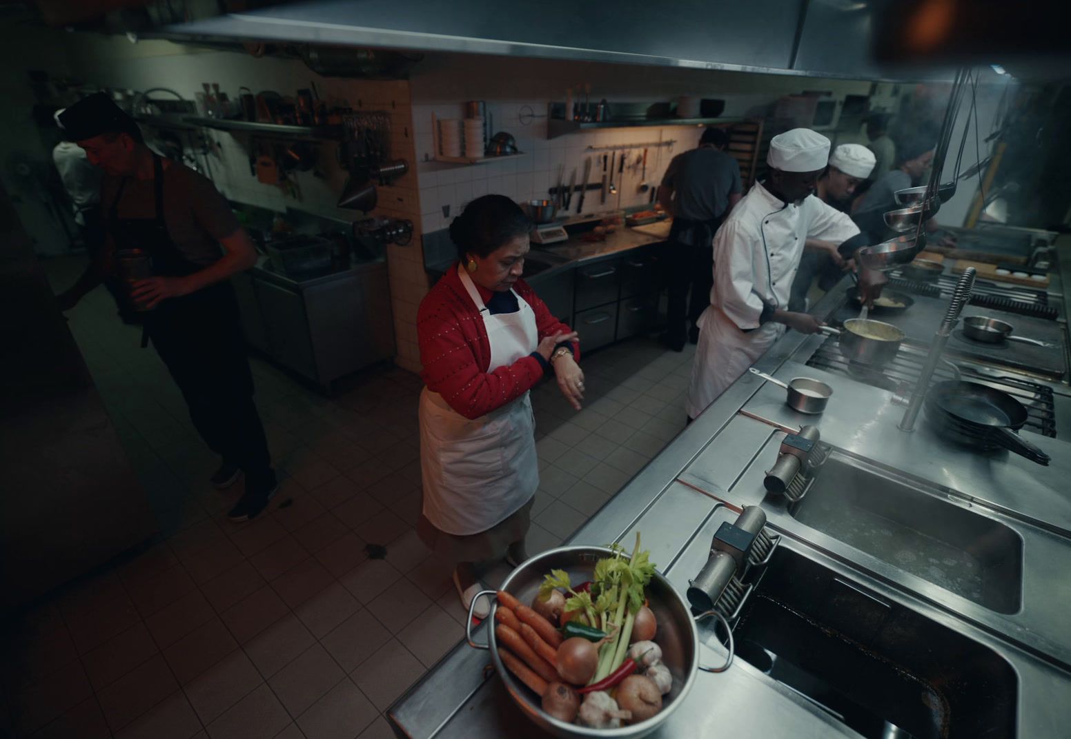 a group of people in a kitchen preparing food