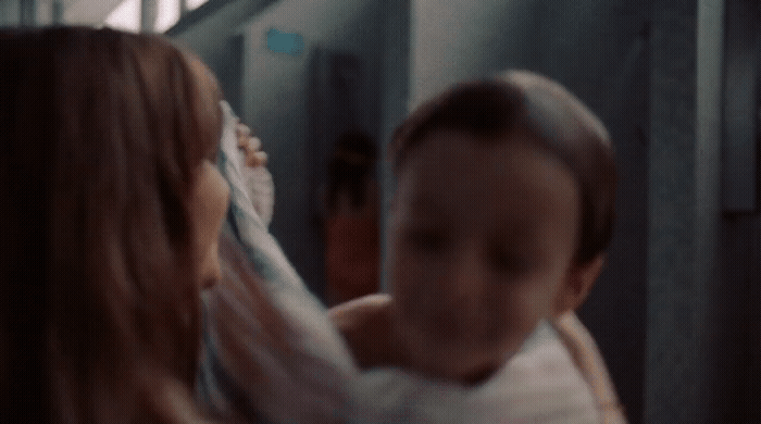 a woman holding a baby in her arms