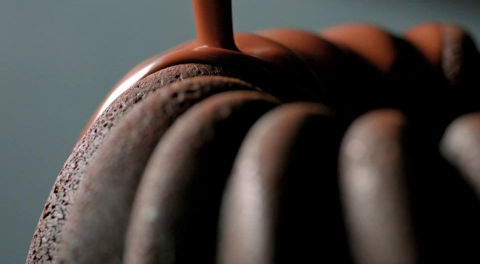 a close up of a chocolate cake with a candle sticking out of it