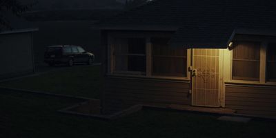 a car parked in front of a house at night