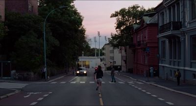 a couple of people walking across a street