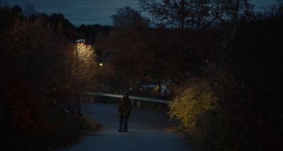 a person walking down a path at night