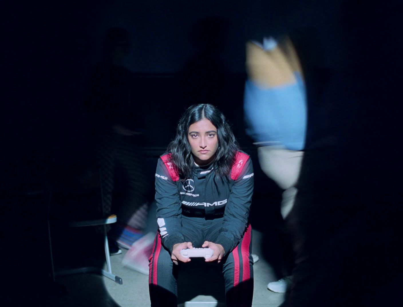 a woman sitting on a chair in a dark room