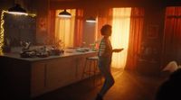 a woman standing in a kitchen next to a counter