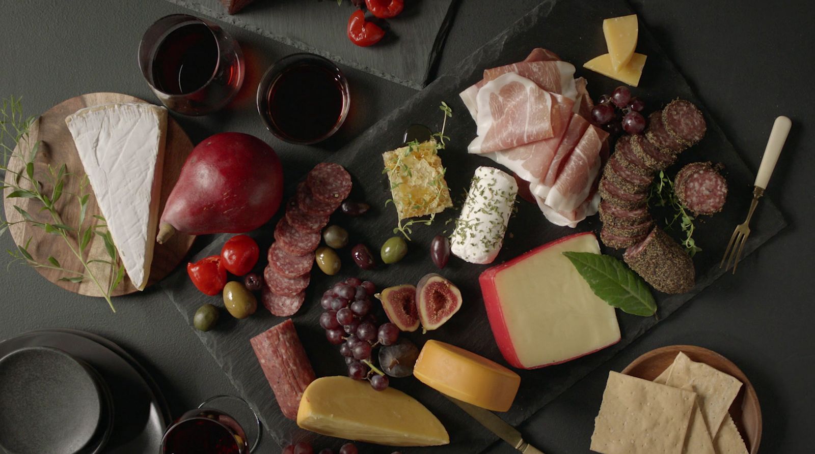 a table topped with different types of cheese and meats