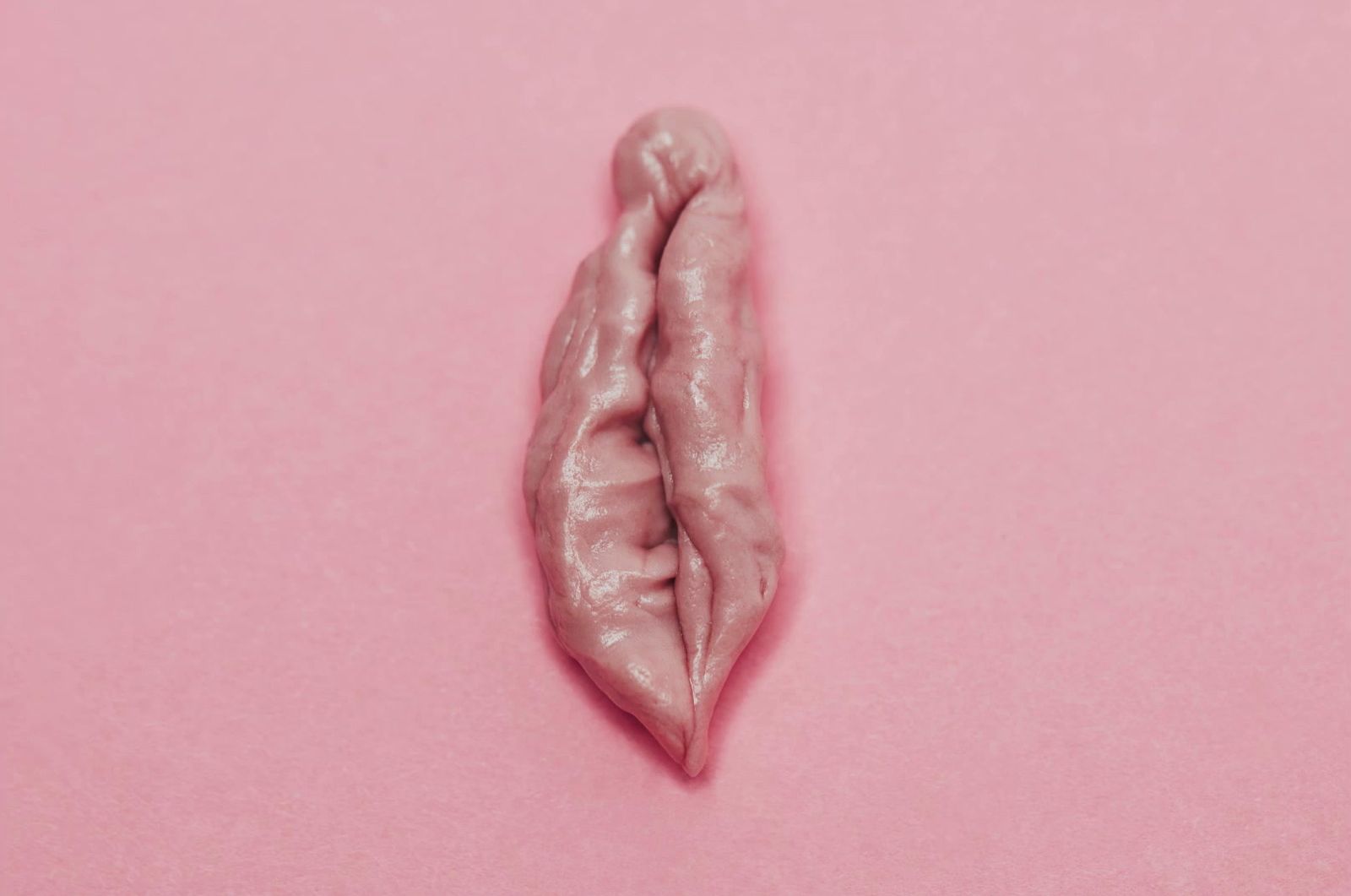 a piece of food that is on a pink surface