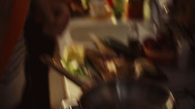 a blurry photo of a person cooking in a kitchen