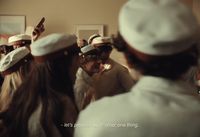a group of people standing around each other