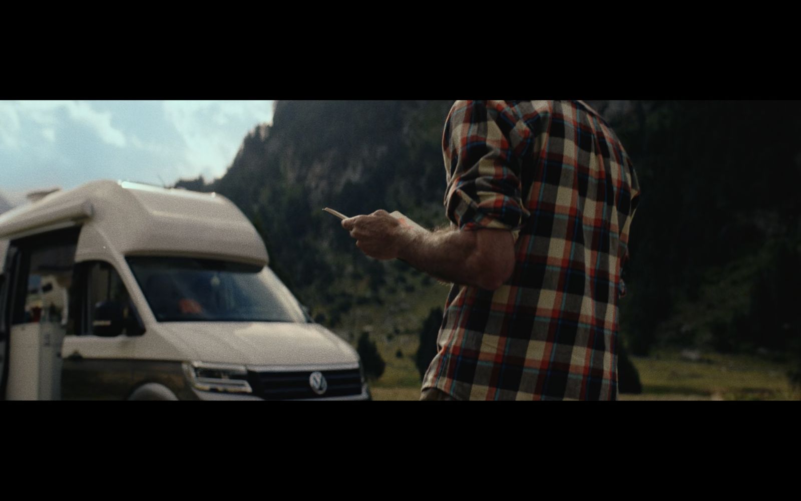 a man standing next to a white van