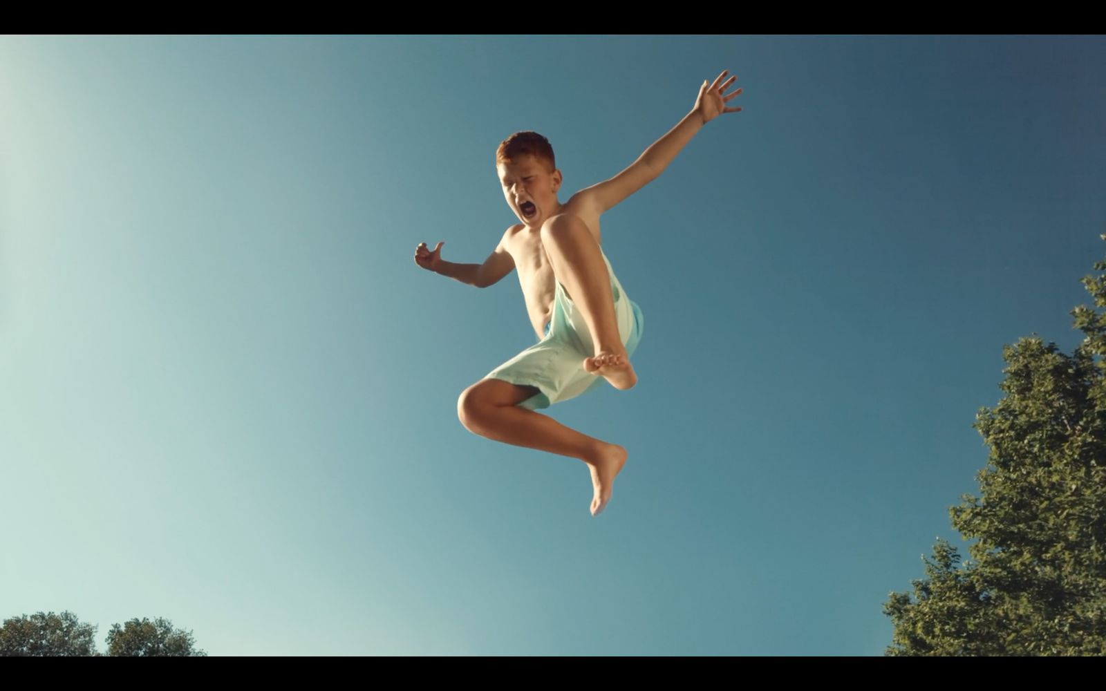 a man jumping in the air with a frisbee