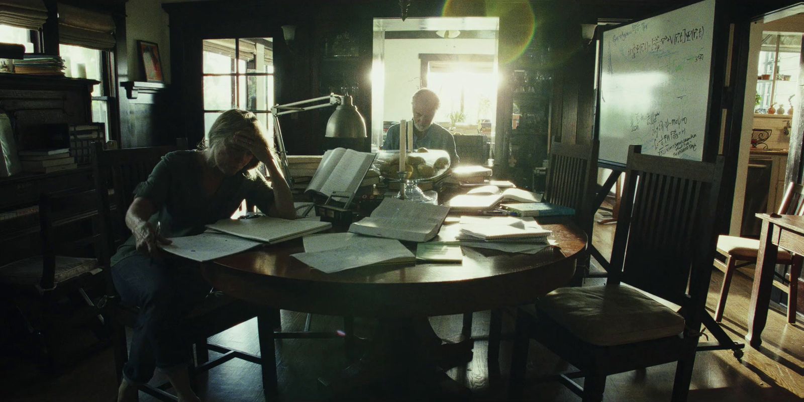 a person sitting at a table with papers on it