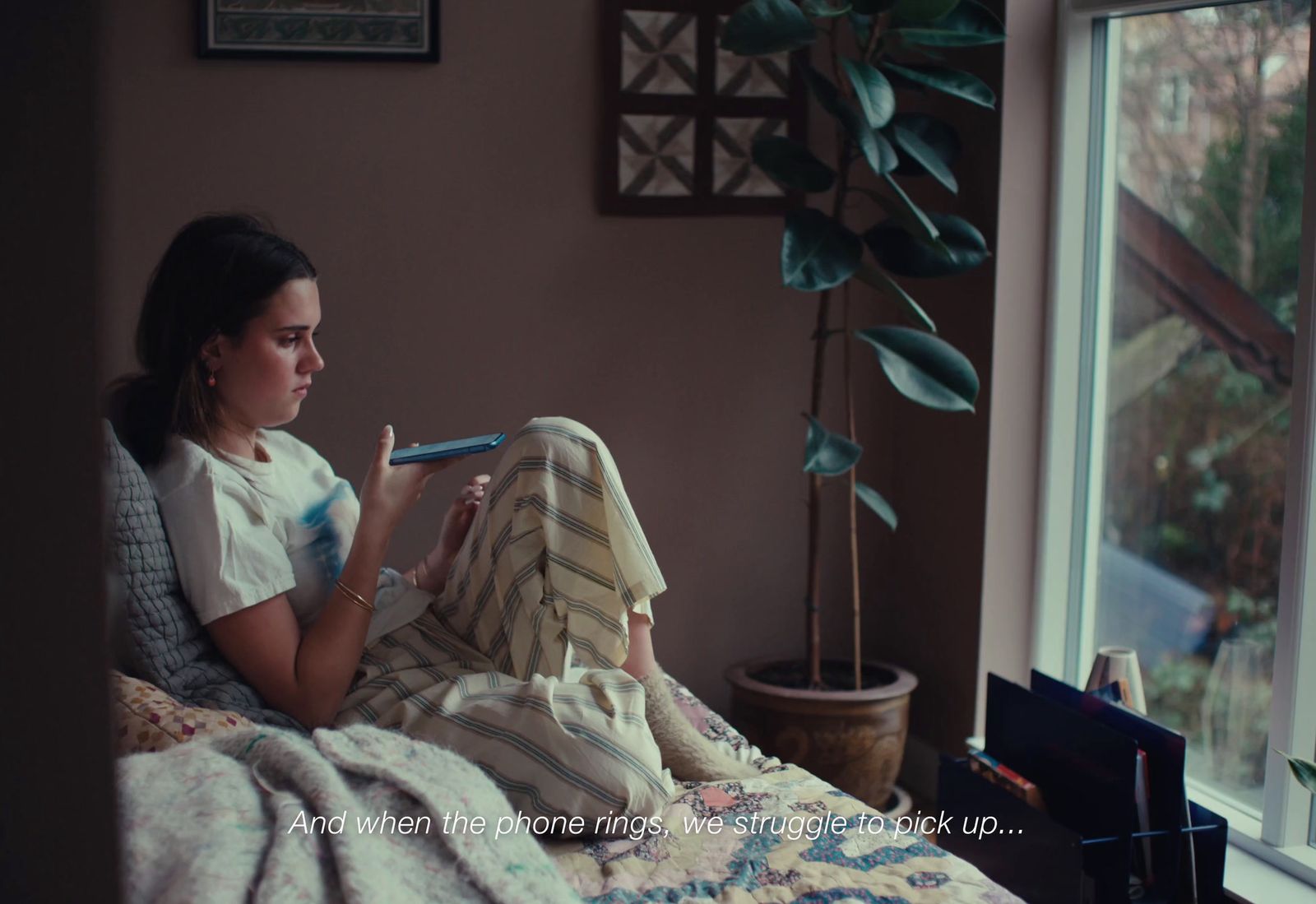a woman sitting on a bed reading a book