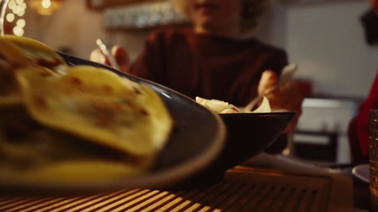 a person sitting at a table with a plate of food