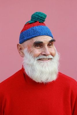 a man with a beard wearing a blue and red hat