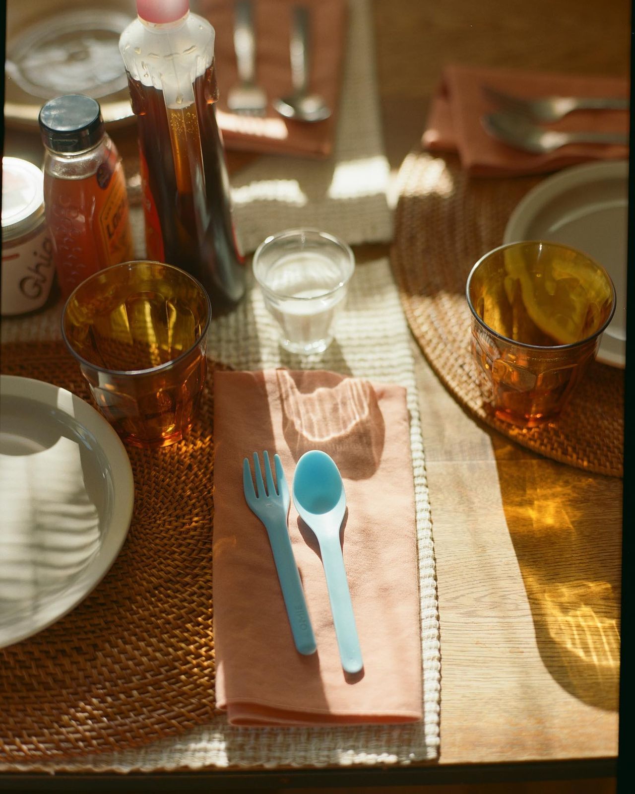 a table with a napkin, a fork, and a cup of tea