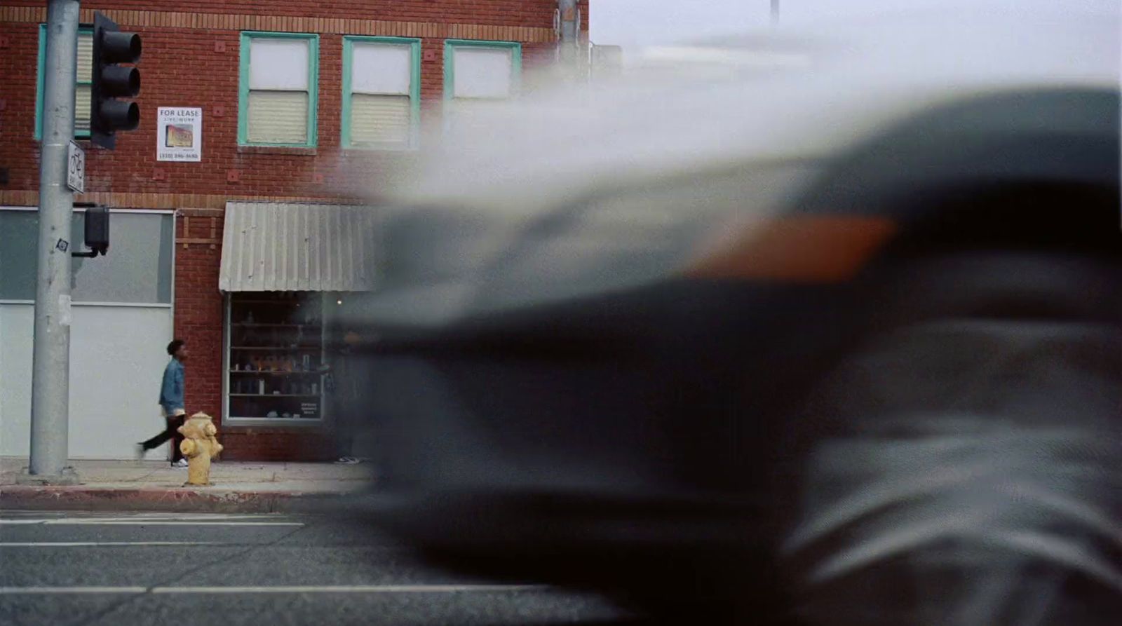 a blurry photo of a person walking down a street