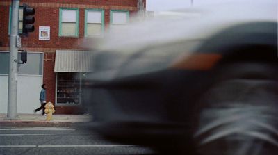 a blurry photo of a person walking down a street
