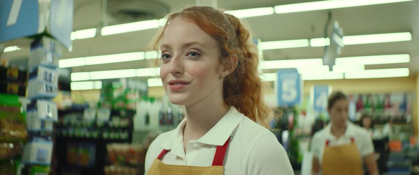 a woman with red hair is standing in a store