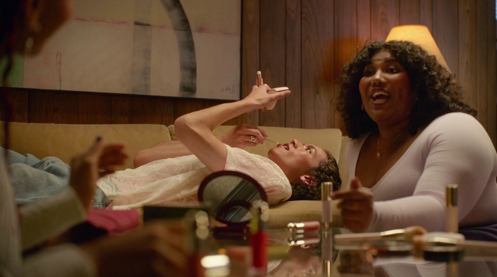 a woman laying on a couch next to a man