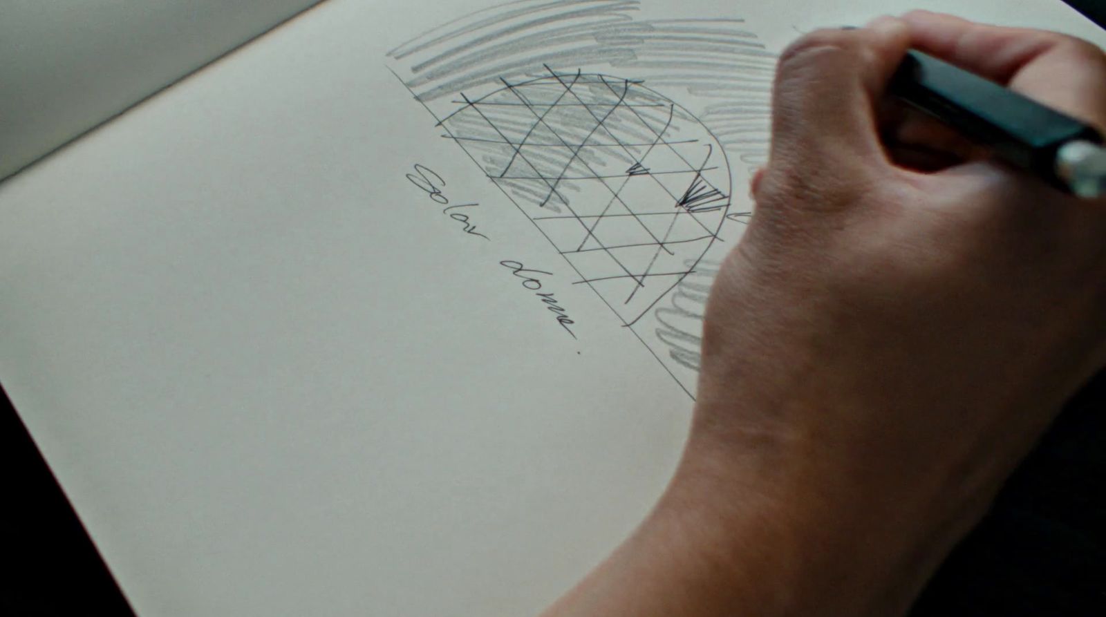 a person is drawing on a piece of paper