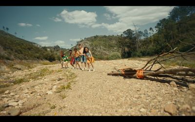 a group of people walking down a dirt road