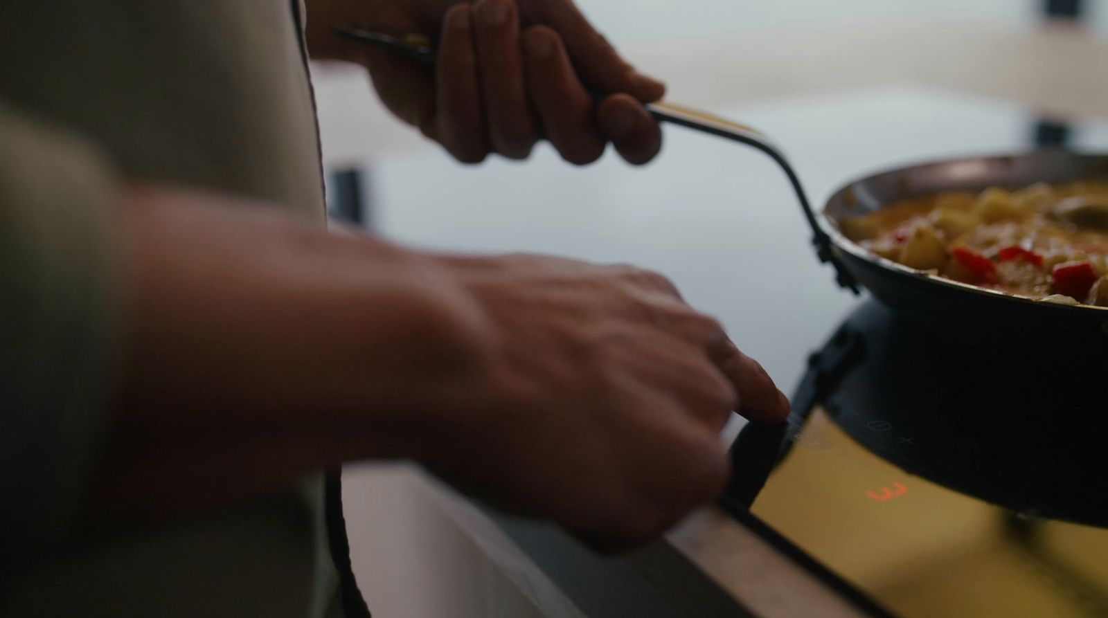 a person is cooking food on a stove