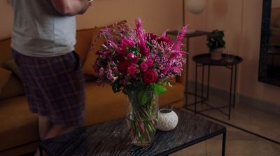 a vase of flowers on a table in a living room