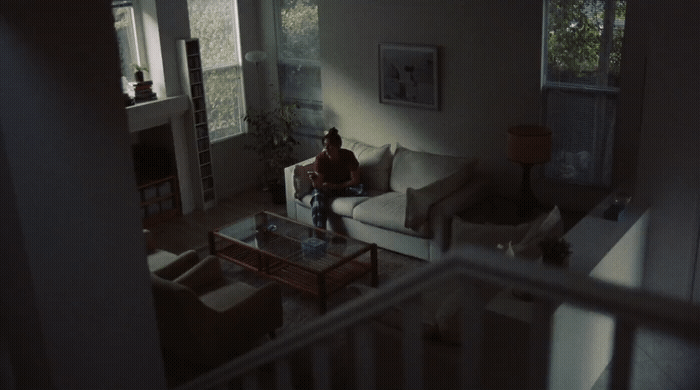 a person sitting on a couch in a living room