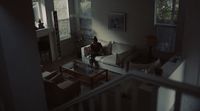 a person sitting on a couch in a living room