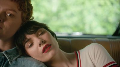 a man and a woman sitting in a car