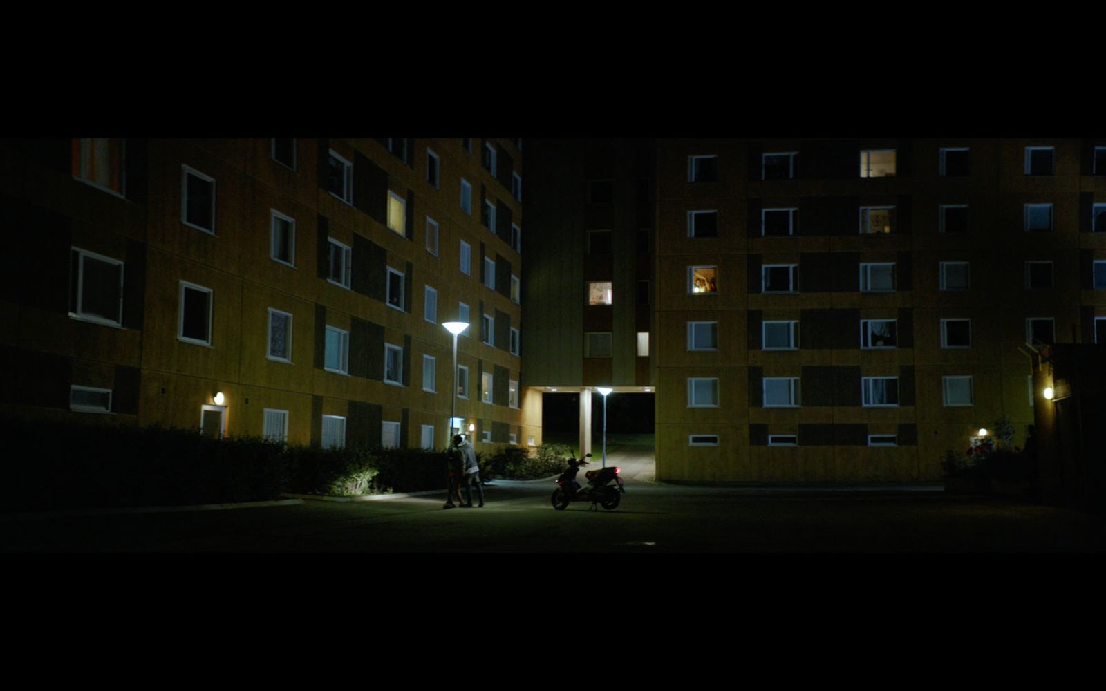 a couple of motorcycles parked in front of a tall building