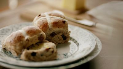 a white plate topped with rolls on top of a wooden table