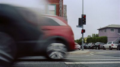 a blurry photo of a red car at a traffic light