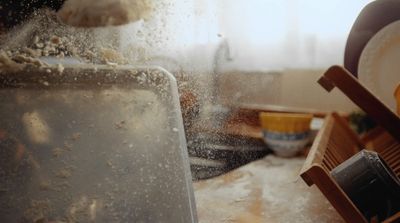 a dirty kitchen counter with a dirty dishwasher