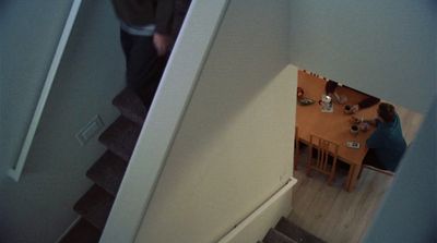 a man standing at the top of a stair case