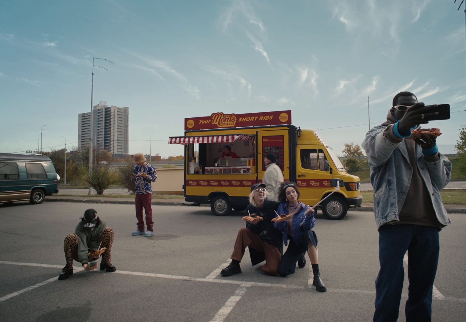 a group of people taking pictures of a food truck