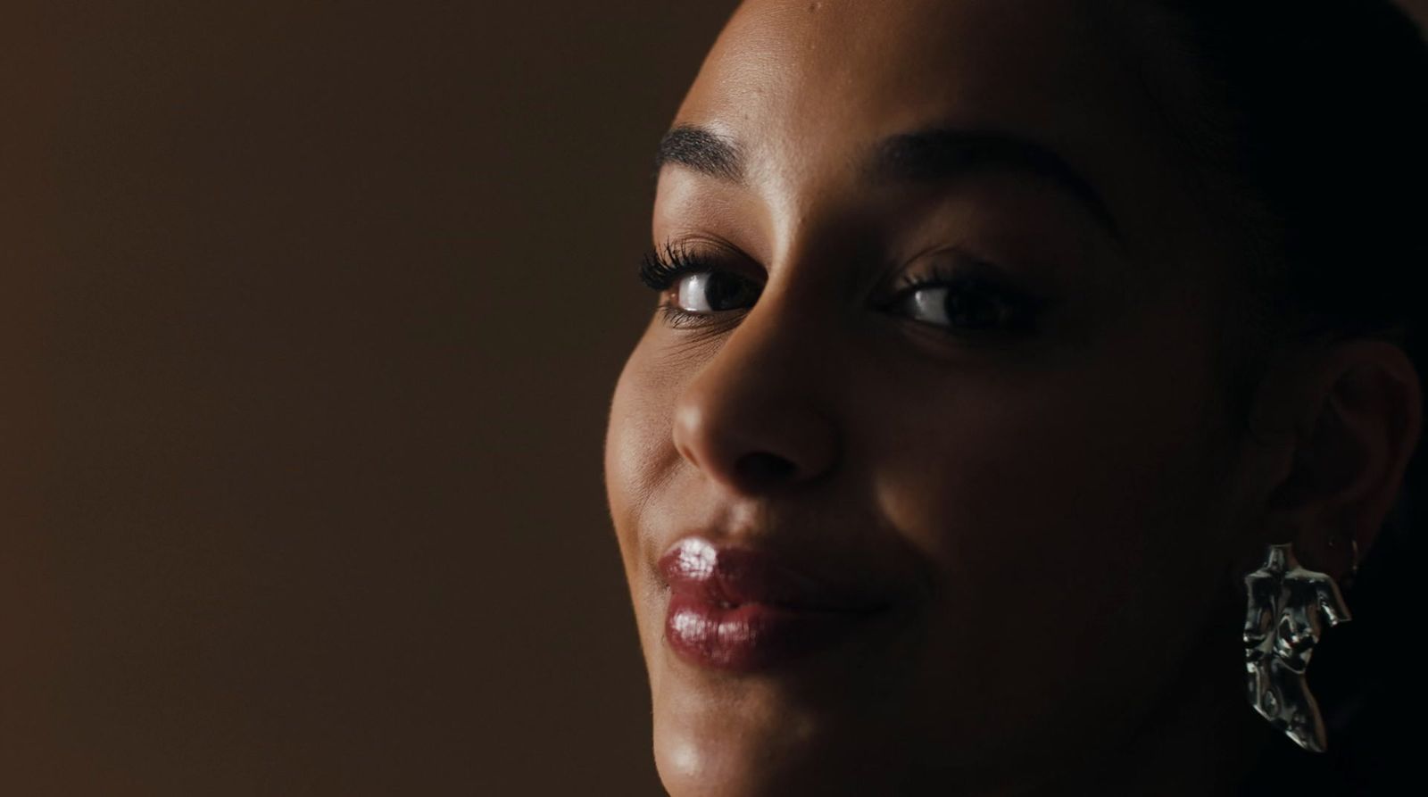 a close up of a person wearing earrings