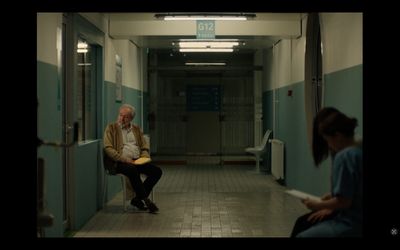 a man sitting in a chair in a hallway