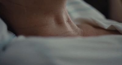 a close up of a person laying in a bed