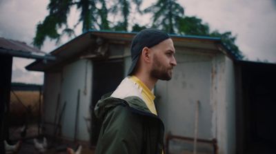 a man standing in front of a shack