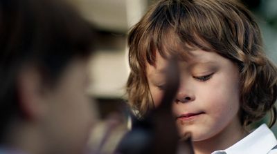 a little boy that is looking at something