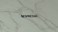 a white marble wall with the word necpresso on it