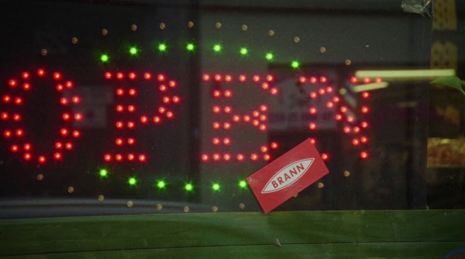 a close up of a red sign with green and red lights