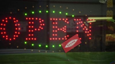 a close up of a red sign with green and red lights