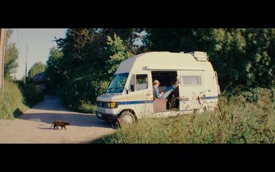 a man and a dog are in the doorway of a van